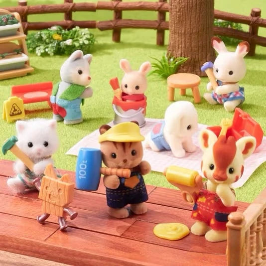 A collection of Sylvanian Families figures, including animals and people, are displayed outdoors on a wooden surface.