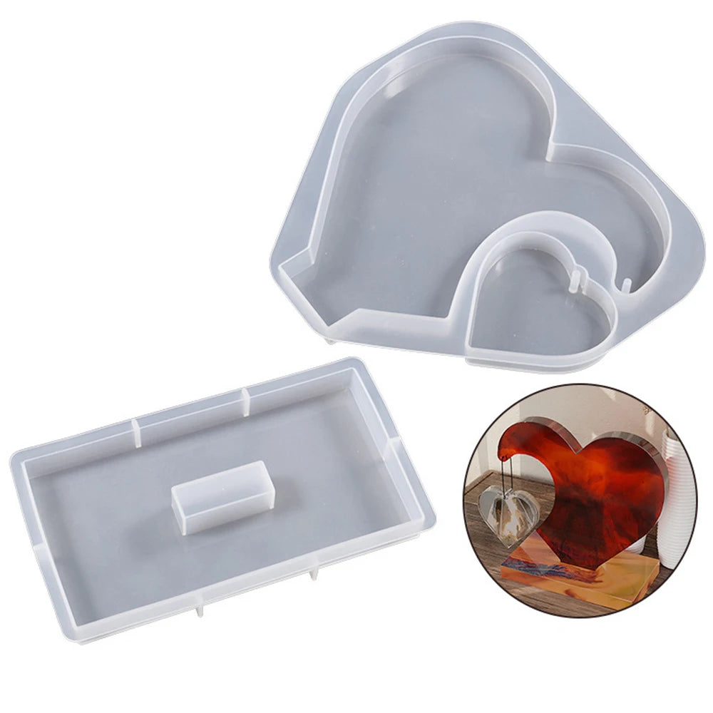 A silicone mold for casting a heart-shaped photo frame in resin.