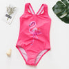 A bright pink one-piece swimsuit featuring a stylized flamingo design for a child.