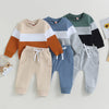 A set of color block sweatshirt and pants for a toddler boy featuring shades of beige, brown, blue, green, and gray.