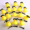 A collection of yellow 3D duck plush hair clips arranged on a white background.