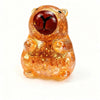 An orange dragon fruit shaped squishy toy with a glossy texture and large eyes.