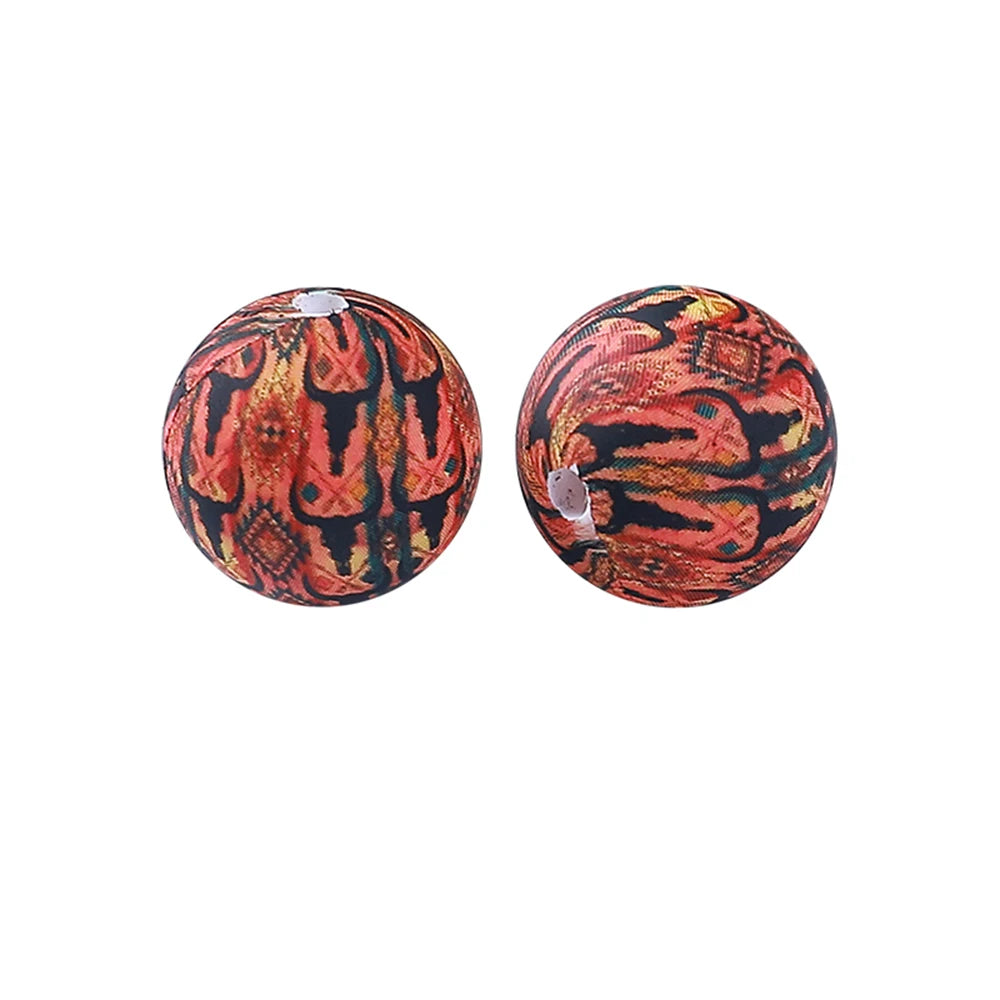 Pair of round, textured silicone beads with an orange and black tiger print pattern.