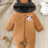 A brown fleece romper for infants with a gray fur hood and a white panda face detail, lying on a cream textured fabric.
