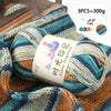 A ball of multi-colored gradient acrylic yarn is shown on a knitted fabric background.