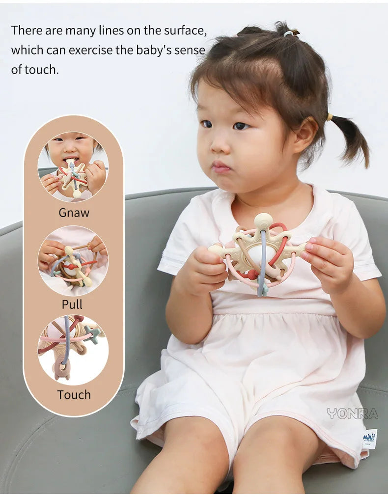A baby is shown interacting with a silicone rattle and sensory ball, demonstrating gnaw, pull, and touch sensations.