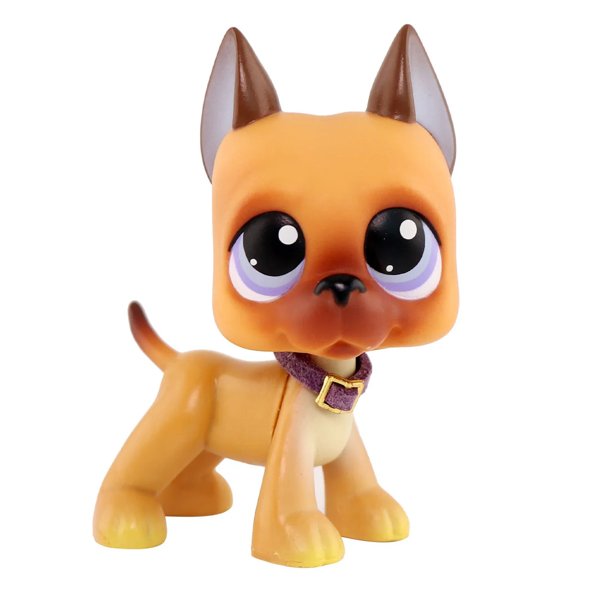 An orange miniature cat figure with large eyes and a purple collar.