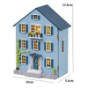 A blue wooden dollhouse kit resembling a house with multiple windows and doors featuring LED lights.