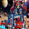 A large, detailed robot figure is shown in a dynamic pose with blue energy effects on a rocky, desert surface.