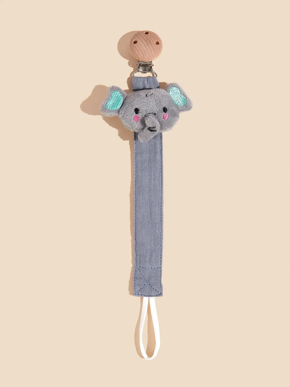 A gray elephant pacifier holder with soft blue ears and a wooden clip attached to a gray strap.