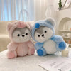 A pair of adorable husky plush toys, one pink and one blue, sitting on a white surface.