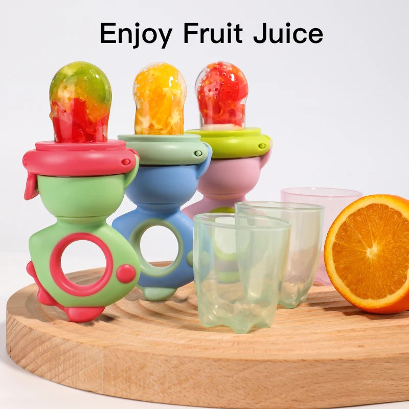 A set of colorful dinosaur-shaped silicone fruit and veggie feeders for babies, including various fruits.