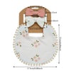 A set of baby flower bib and headband featuring a pink bow and a white floral bib.