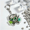 Silver and green anime-inspired acrylic keychain charm featuring a character in a futuristic helmet