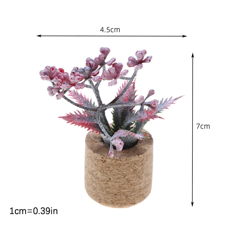 A small, pink and gray miniature plant with delicate foliage is potted in a natural fiber material.