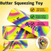 A yellow and pink butter-shaped squeezing toy is shown with a hand, demonstrating its soft texture and unique design.
