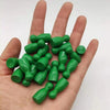 A hand holds a set of ten green wooden chess pawns for board games.
