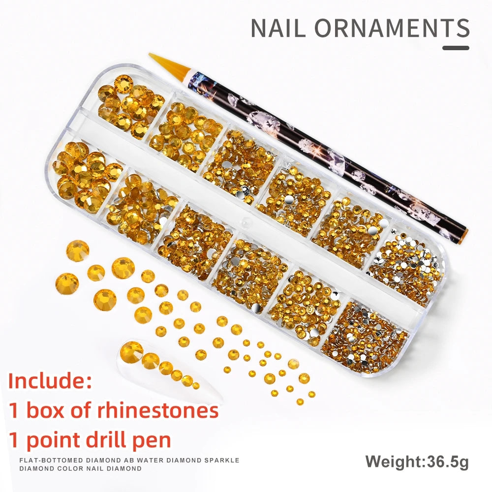 A box of gold rhinestones, a point drill pen, and diamond sparkle nail decorations are shown on a white background.