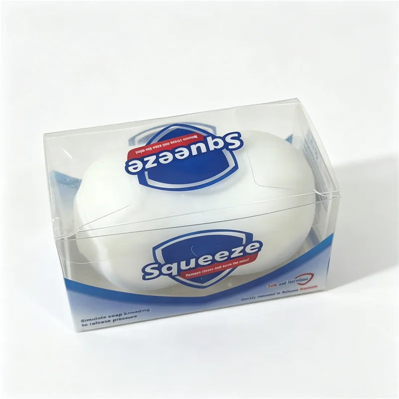 A clear plastic package containing a white squishy fidget block for stress relief and sensory play.