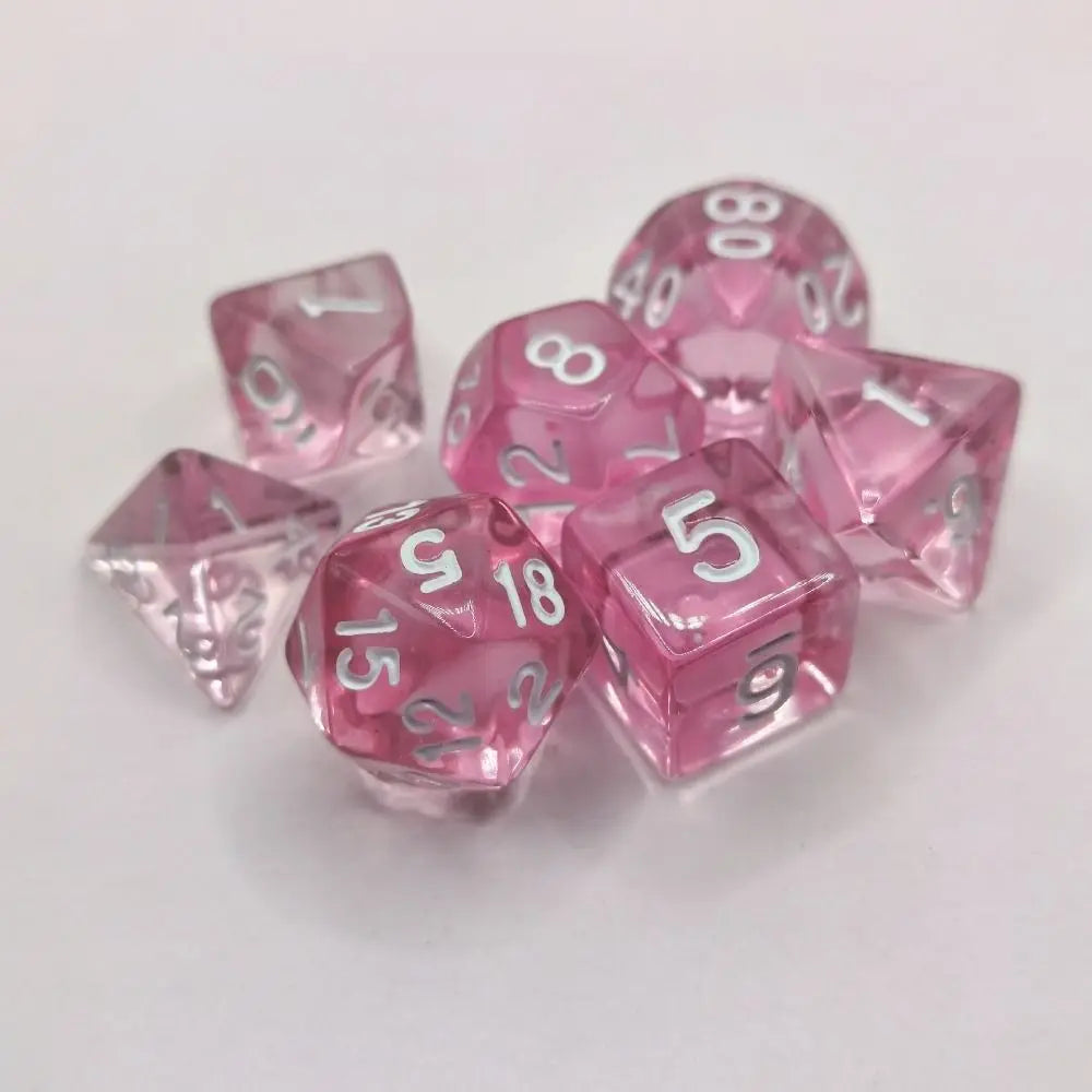 A set of ten pink acrylic polyhedral dice, including d8s and d10s, scattered on a white surface.