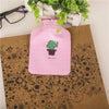 Pink fabric cover for a portable hot water bottle with a green cactus design
