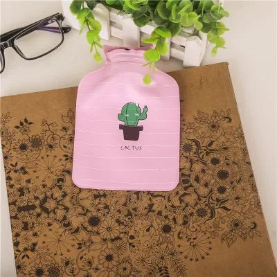Pink fabric cover for a portable hot water bottle with a green cactus design