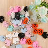 A collection of pink, gray, and black silicone ghost-shaped beads for jewelry making.