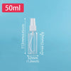 A clear glass refillable travel spray bottle with a fine mist pump is shown against a light blue background.