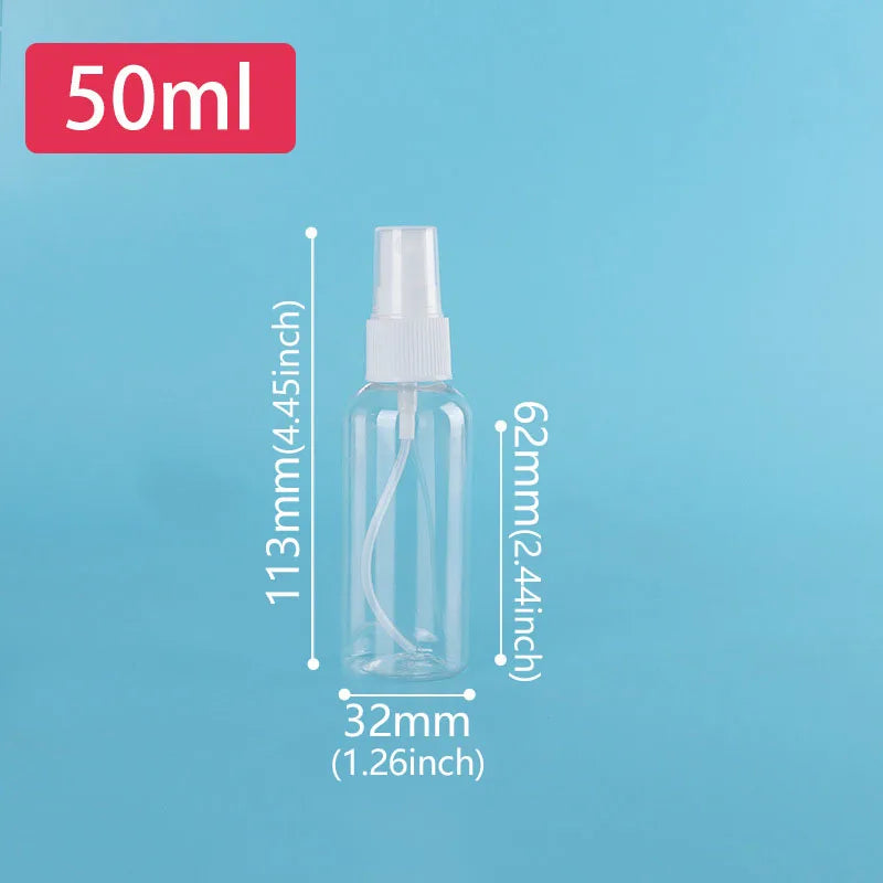 A clear glass refillable travel spray bottle with a fine mist pump is shown against a light blue background.