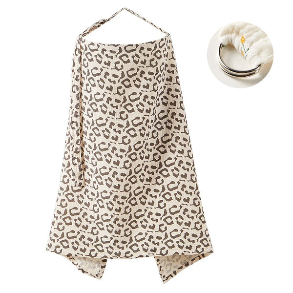 A beige leopard print pure cotton nursing cover with a gold necklace displayed next to it.