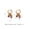 Gold-toned hoop earrings featuring tiger's eye stone pendants made of stainless steel