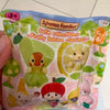 A plastic bag containing a Sylvanian Families Cutie Collectibles Fruity Babies series figure.