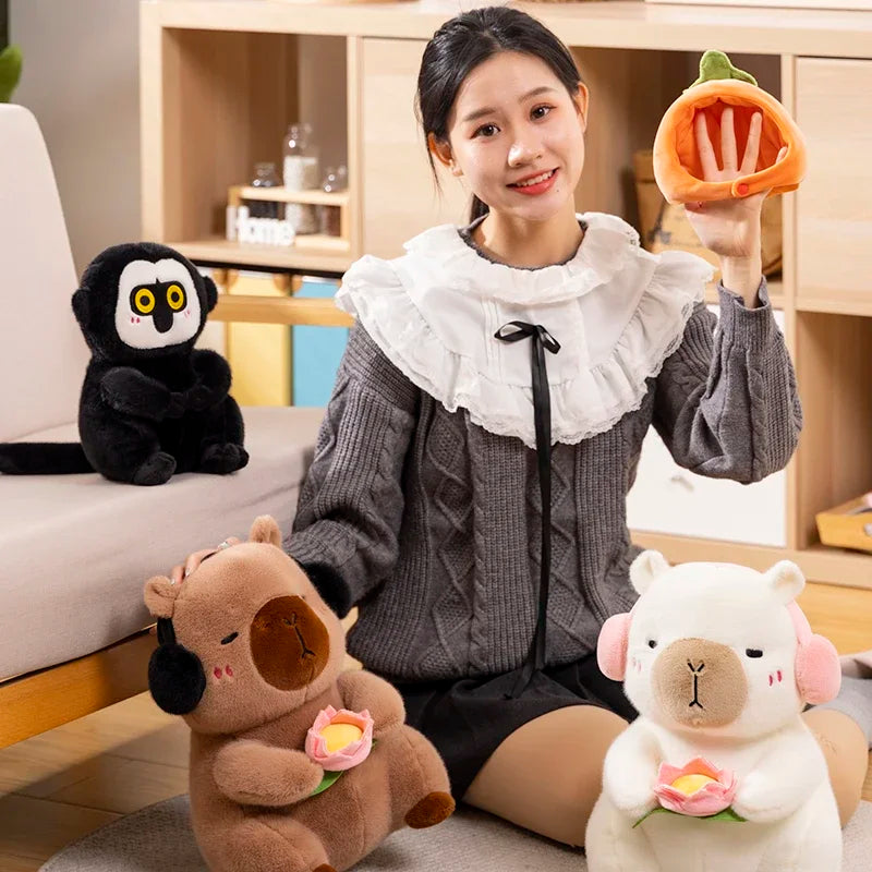 A woman is holding an orange capybara plush toy with a pink lotus flower.