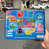 A box of Squishy Fun Box sensory toys featuring strawberry, ice, and butter themed squishies.