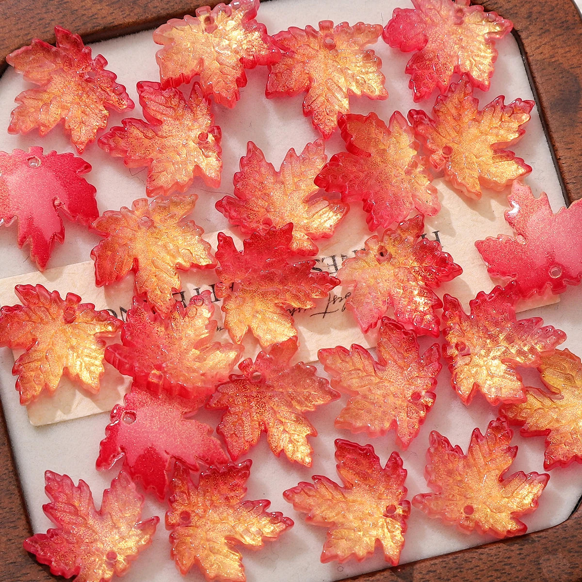 A collection of bright orange and pink maple leaf glass beads for DIY jewelry making