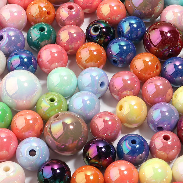 A collection of colorful round acrylic spacer beads in various shades including pink, purple, green, and orange.