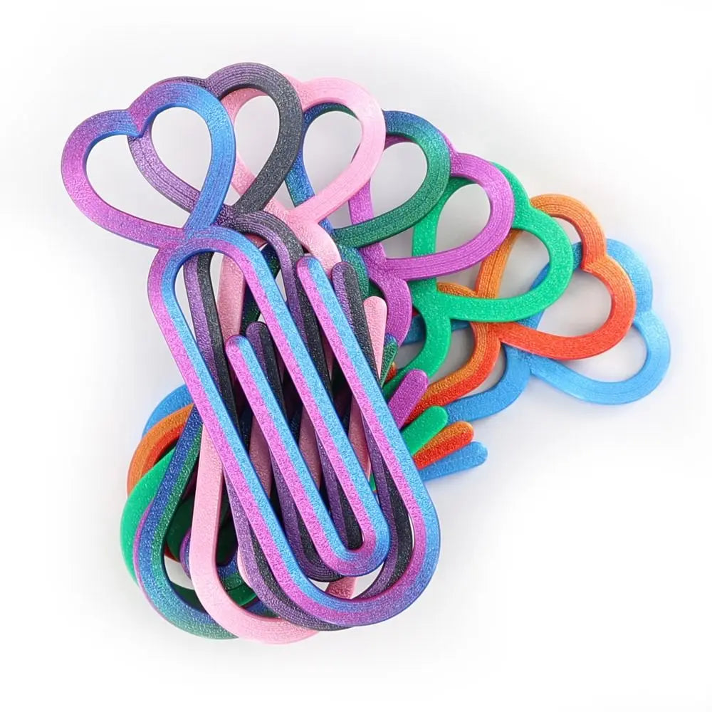 A collection of heart-shaped canvas clips in various shades of purple, pink, green, and orange.