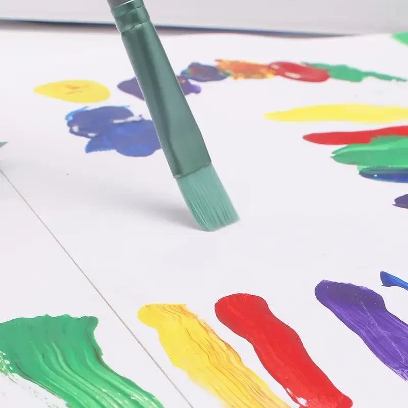 A paintbrush is shown dipping into various colorful paint blobs on a white surface.