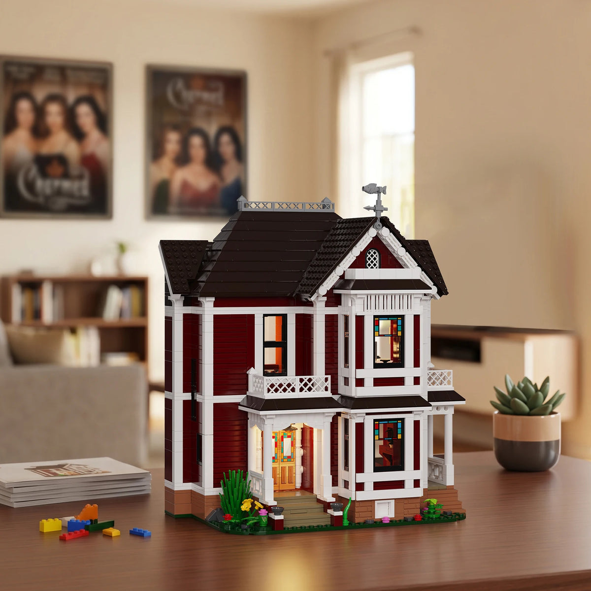 A detailed model kit of a red and white Charmed house built from building blocks on a wooden table.