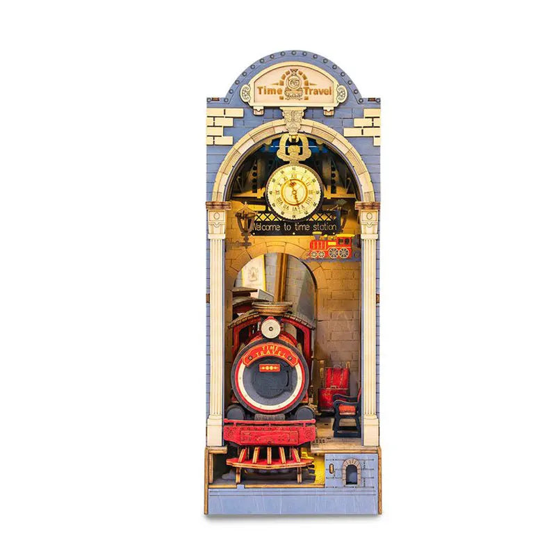 A miniature dollhouse kit featuring a vintage train station facade with an ornate arch and clock.