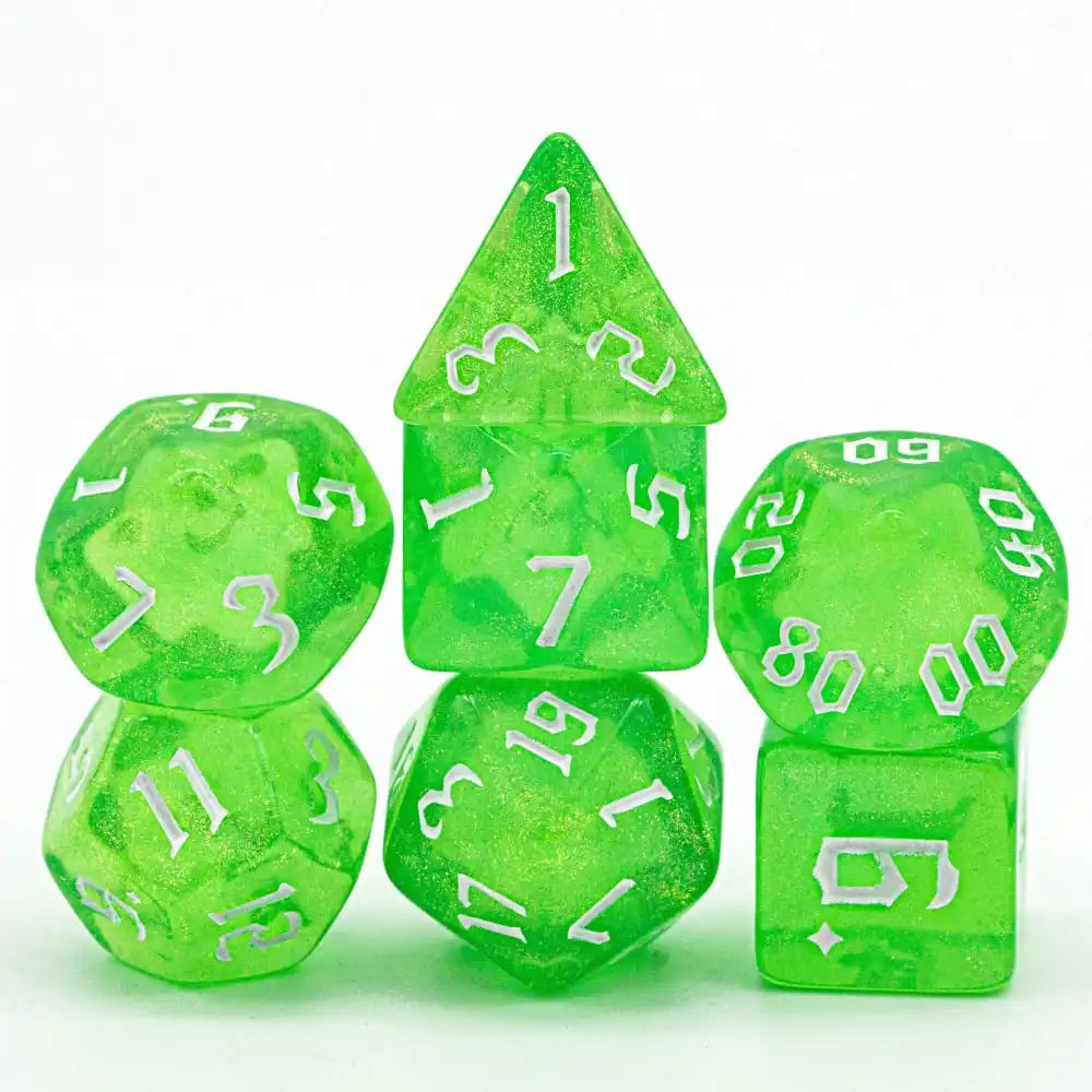 A set of seven translucent green glitter polyhedral dice, including a tetrahedron and a dodecahedron.