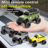 A hand holds a green mini remote control off-road vehicle with a three-speed transmission and directional cruise feature.