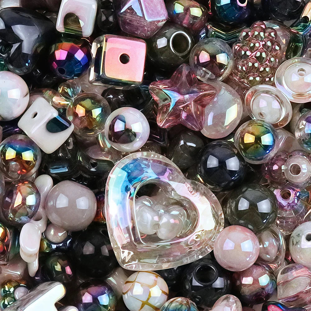 A close-up view of various iridescent and colored acrylic beads, including bow shapes and flowers, for DIY jewelry making.