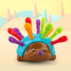A colorful hedgehog toy with spiky protrusions used for fine motor skills and color sorting.