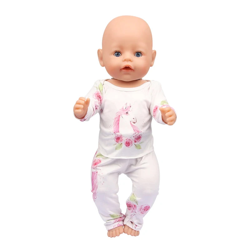 A baby doll wearing a white unicorn pajama set with pink floral accents.