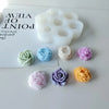 A set of white silicone molds shaped like flowers and other decorative objects for crafting.