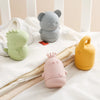 Three soft silicone animal bath toys in gray, light green, and yellow are displayed on a white surface.