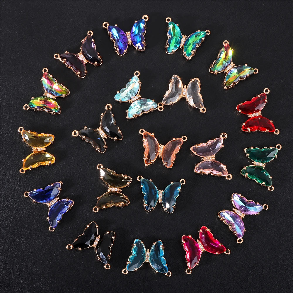 A collection of colorful crystal butterfly charm beads arranged in a circular pattern.