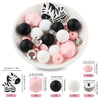 A white bowl filled with black and pink cartoon animal silicone beads, including tiger and zebra shapes.