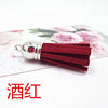 A cluster of deep red velvet tassels with silver metal findings for DIY jewelry and decor.